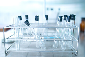 scientist doing research on plants holding a green solution in a test tube