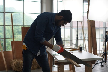 Carpenter or warehouse worker choosing raw wood material for the work at the carpentry storage