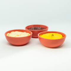 Mayonnaise, mustard and ketchup creams in containers.