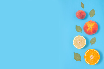 Blue summer background with tropical fruits
