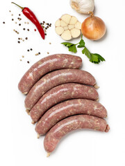 Turkey meat sausages with vegetables on white background. Top view.