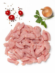 Turkey breast meat fillet sliced on pieces decorated with vegetables on white background. Top view.