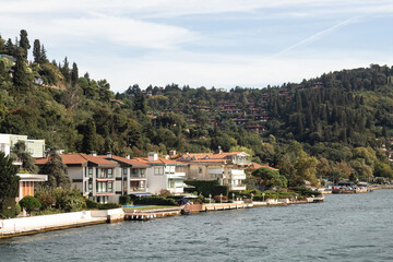 Fototapeta premium View of historical and traditional mansions by Bosphorus in Kandilli area of Asian side of Istanbul. It is a sunny summer day. Beautiful scene.
