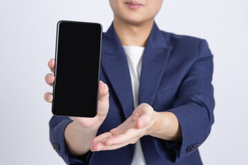 Businessman showing mobile smartphone with blank screen