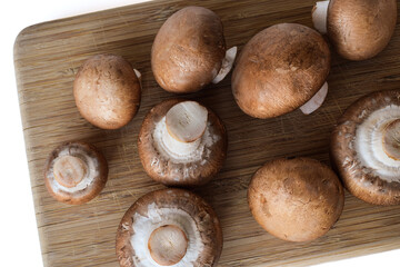 Cremini mushrooms on wooden cutting board