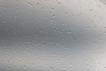 Silver car panel in the rain. Close up