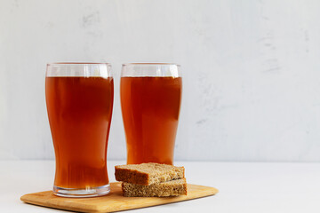 summer iced drinks. glass of beer and sandwich on the cutting board. two high Glasses of fresh...