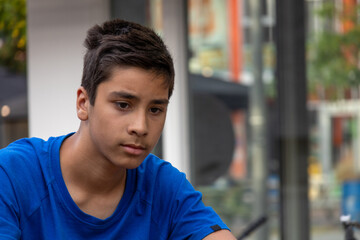 Fototapeta premium A young boy teenager sads about something