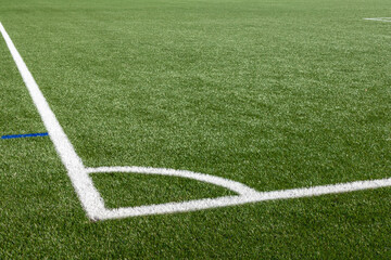 Obraz premium Football field with artificial turf and white markings, detail .