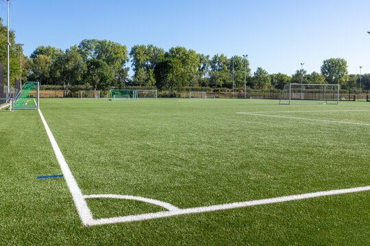 Football field with artificial turf and white markings for practice.