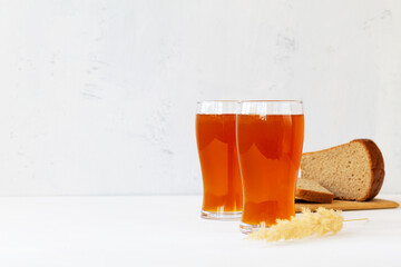 glass of beer. two high Glasses of fresh kvass with bread on white background with copy space.
