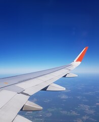 Fototapeta na wymiar Airplane flies in the blue sky