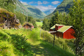 A hiking trail on the historic mesmerizing Vindhellavegen with several switchbacks / hairpin bends through the beautiful green hills of Borgund, Laerdal, Norway