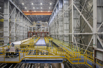 Special equipment with belt conveyor in factory workshop.