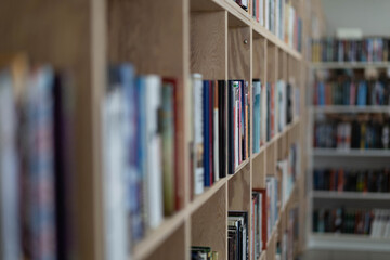 Shelves with books in a bookstore. Education and development. Blurred. Horizontal photo. A great background for your design. 