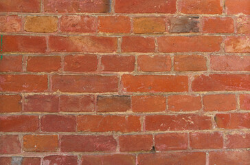 Large texture of a wall lined with red bricks. Close-up.