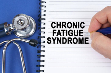 On a blue surface lies a stethoscope and a notebook in which it is written by hand - Chronic Fatigue Syndrome