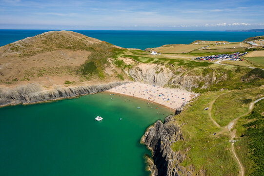 Aerial view of a busy beach and bay in West Wales (Mwnt, Ceredigion)