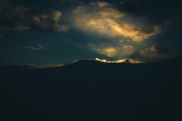 Sunset cloudy sky with the orange sun