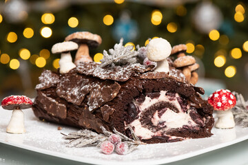 Christmas yule log cake with meringue mushrooms