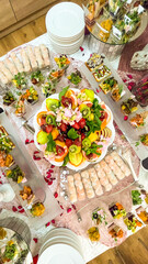 catering table covered with snacks and various dishes top view