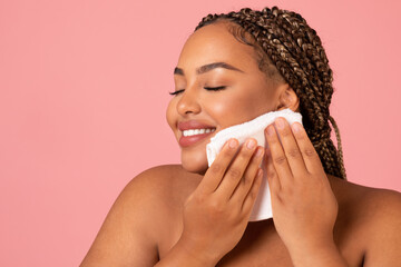 African American Lady Drying Face With Towel Over Pink Background