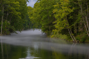 Summertime fog hangs lightly over the South Holston River, Tennessee
