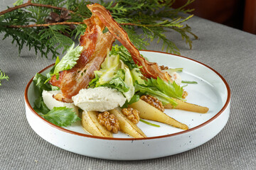 Salad with pear, bacon and walnuts. Haute cuisine, beautiful service.