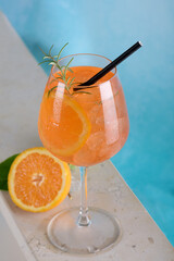Classic italian aperitif aperol spritz cocktail in glass with ice cubes with slice of orange by a...