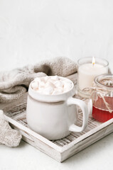 Fototapeta na wymiar Cocoa or coffee cup with marshmallow on wooden tray. Christmas and new year holiday concept. Cozy winter home background.