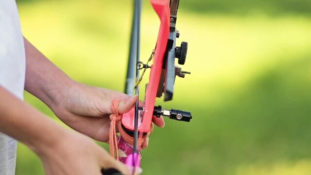 Close-up of the complete process of archery preparation for shooting an arrow from the bowl. Archery outdoors