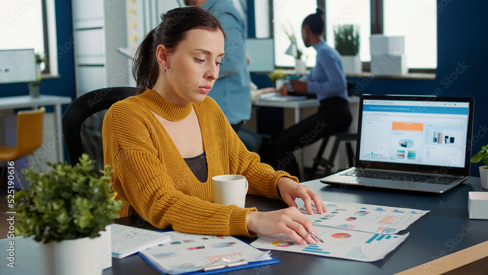 Aufkleber portrait of startup employee comparing two sheets of paper with charts analyzing financial data whil