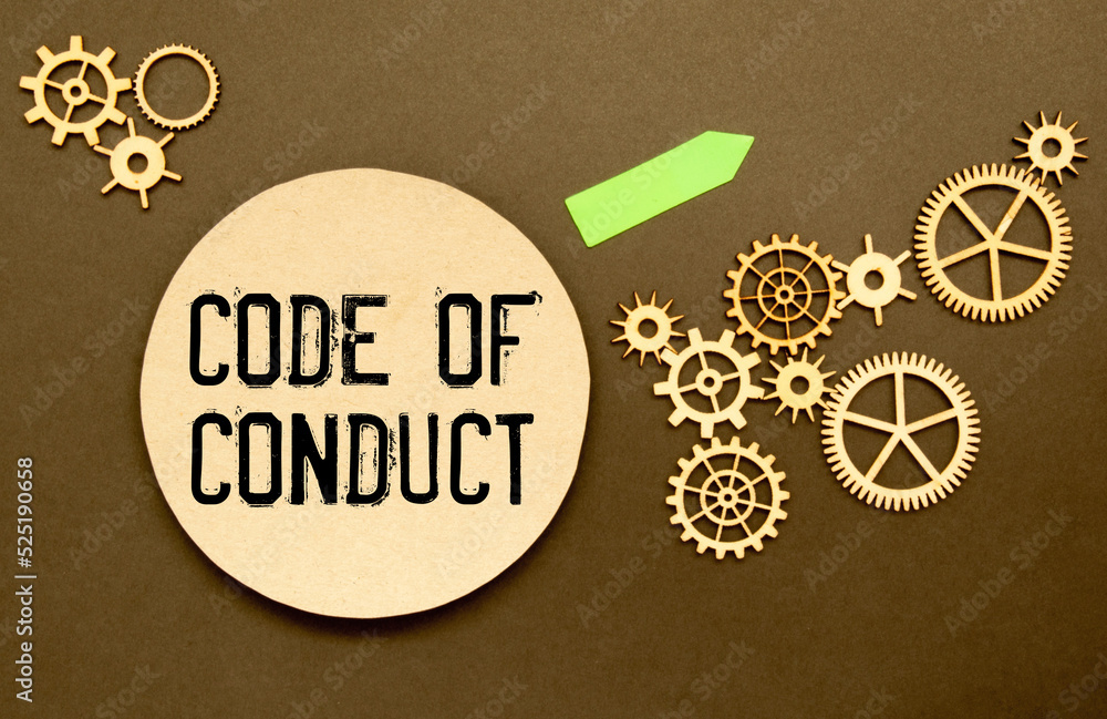 Poster business concept. notebook with text code of conduct on pink paper with magnifier