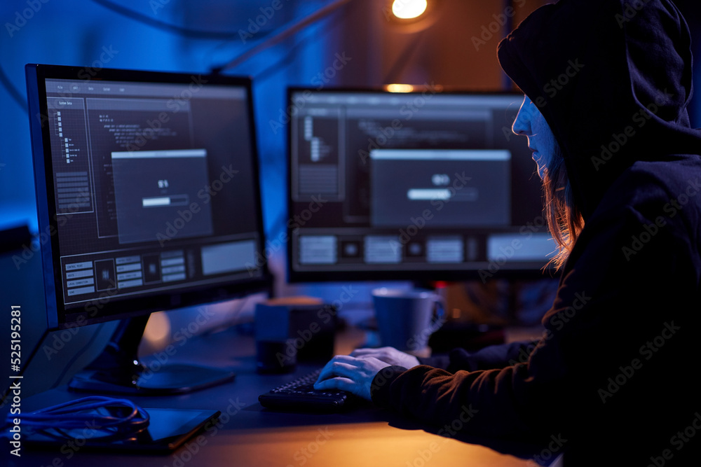 Poster cybercrime, hacking and technology concept - female hacker in dark room writing code or using comput