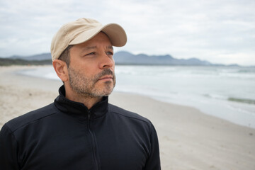 Man at the beach in brazil looking to the horizon