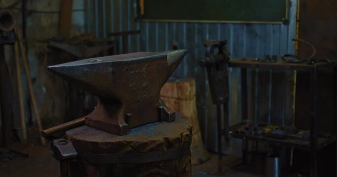 anvil, vice and other equipment in ancient blacksmith craft workshop, inside old forge, 4K, Prores