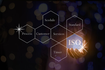 A hand holding the ISO polygon with word bokeh black background standard quality document control for organization and industry management products, copy space for text