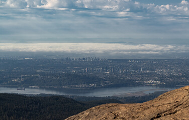 Beautiful Nature Landscape View from the Mountain Top and Downtown City in the Background during a summer sunrise