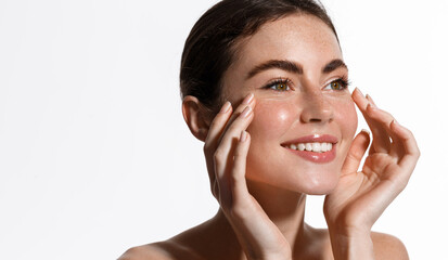 Beauty and skin care. Smiling girl cleansing her skin, rubbing in facial cream, moisturizer gel...