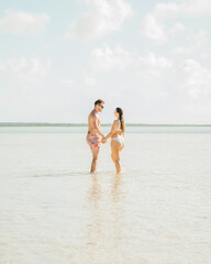Young Couple walking on the beach. Exuma, Bahamas