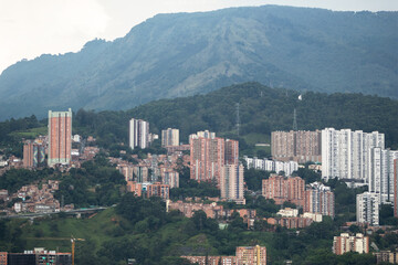 Obraz premium Buildings built on a mountain and surrounded by lots of greenery. Medellin Colombia.