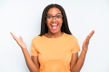 black young adult woman feeling happy, excited, surprised or shocked, smiling and astonished at...