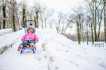Fototapeta na wymiar girl walking around outdoors in the winter, playing with snow