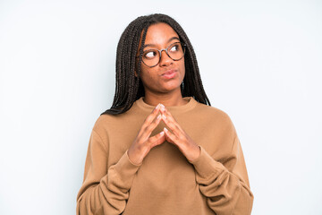 black young adult woman scheming and conspiring, thinking devious tricks and cheats, cunning and...