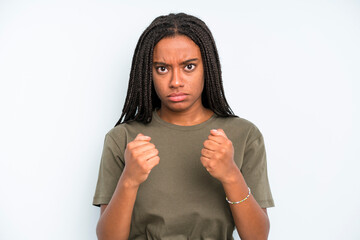 black young adult woman looking confident, angry, strong and aggressive, with fists ready to fight...