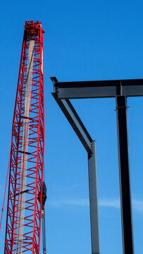 Construction site with I-beam and crane. 