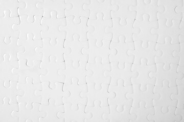 Blank white puzzle as background, top view