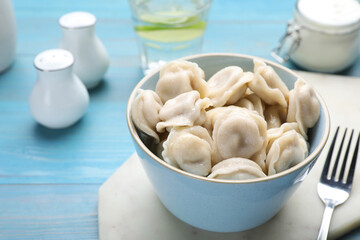 Delicious dumplings on turquoise wooden table, closeup