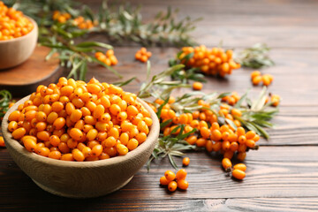 Fresh ripe sea buckthorn on wooden table. Space for text