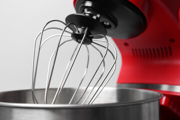 Modern red stand mixer on light grey background, closeup